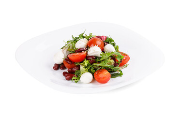 A plate with a salad of tomatoes, beans, and mozzarella