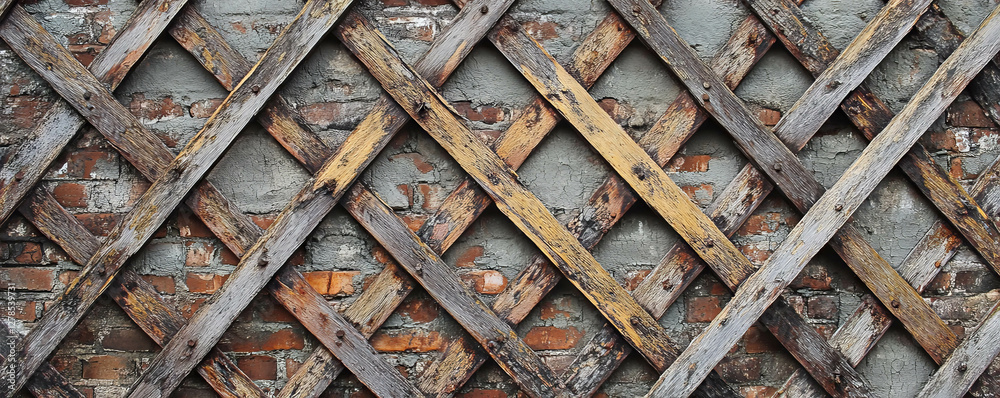 Poster rustic wooden lattice texture on weathered brick wall for background and design