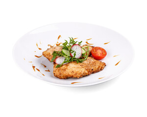 A white plate beautifully topped with meat and various vegetables