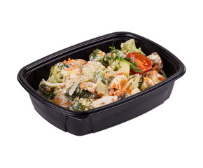 A black plastic container that is completely filled with broccoli and tomatoes