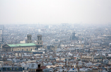 Naklejka premium Expansive cityscape viewed from above. Urban density, uniform architecture, and a sense of scale.