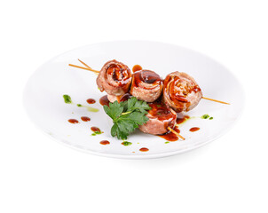 A white plate with meat skewers and sauce on a white background