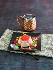 blancmange dessert topped with strawberry sauce