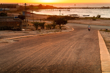 Road to Coche Islands, Venezuela. Beautiful light at the end of the day. Road to freedom, motor racing into the sunset.