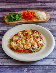 naan 'pizza' topped with sautéed shrimp and ricotta sauce