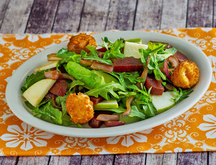 roasted beets and fried goat cheese on a bed of mixed greens