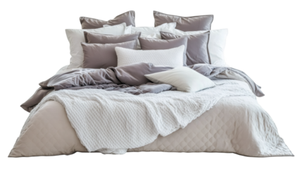 Unmade bed with soft pillows and rumpled blankets creating welcoming, comfortable sleeping environment against clean white background