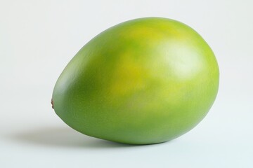 A Single Green Mango Rests on White Background