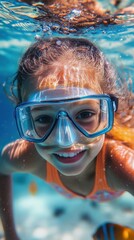 Fototapeta premium Joyful Young Girl Swimming Underwater in a Pool, Wearing Snorkel Gear and Splashing Around, Capturing the Essence of Summer Fun and Aquatic Adventure