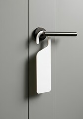 Close-up of modern door handle with blank white do not disturb sign