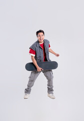 Portrait of asian man playing skateboard on white background