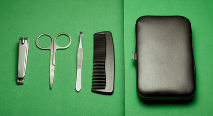 Flat lay of a manicure set on a green background.