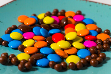 Macro shot of vibrant chocolate candies in assorted colors, perfect for dessert and snack-themed visuals