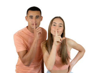 Young diverse couple smiling with silence gesture or keep secret over transparent background. PNG transparent