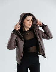 Portrait of a cute girl model in a leather jacket on a white background isolated in the studio