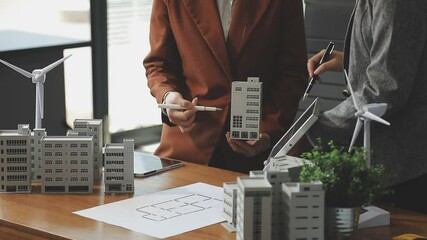 Diverse team engaged in meeting about environmental social corporate governance, highlighting sustainability strategies and goals. Eco-Friendly Business Team Discussing ESG Goals.
