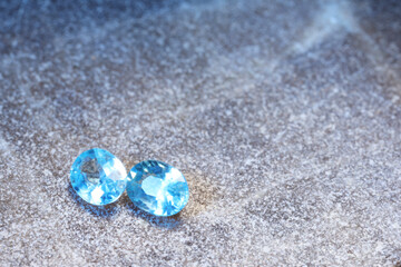 Beautiful shiny light blue gemstones on stone, space for text