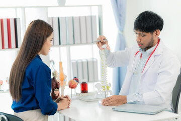 Fototapeta premium A male orthopedist gives advice to female patients and lectures to female patients in the hospital. medical health care