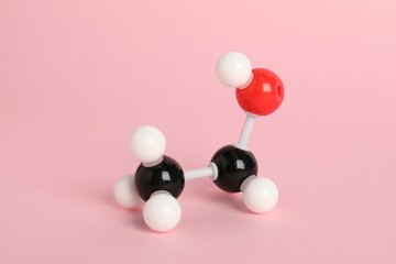 Molecule of ethanol on pink background. Chemical model