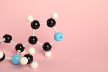 Chemical model of molecule on pink background, closeup. Space for text