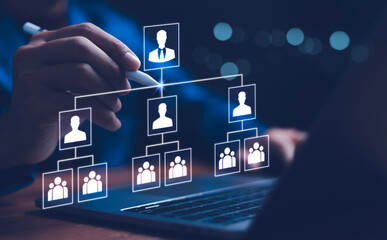 Businessman point a glowing digital organizational chart, leadership and team structure. Manager...