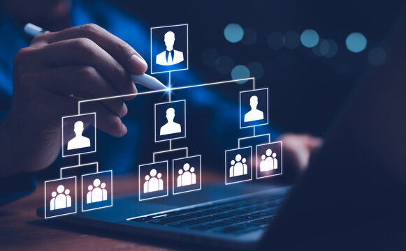 Businessman point a glowing digital organizational chart, leadership and team structure. Manager team management of company, networking in business hierarchy job concept, president job change control