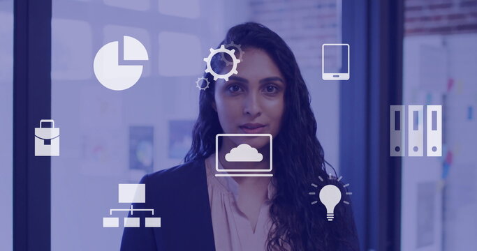 Image of business icons over biracial businesswoman in office