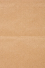Close-up detail of a brown paper bag, highlighting its texture and folds