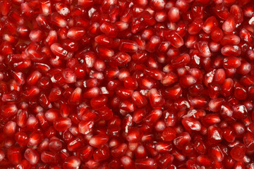 A close-up shot of pomegranate arils, showcasing their vibrant red color and juicy texture