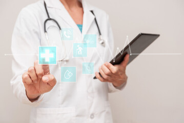 Close up of Doctor using futuristic holographic icons interface for healthcare, innovative medical technology concept