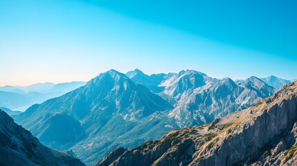 Majestic Mountain Range Under Clear Blue Sky in Stunning Landscape