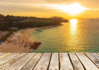 Wooden table top on the beach or sea.Party on the beach  sunset time concept.For montage product display or design key visual layout.View of copy space.