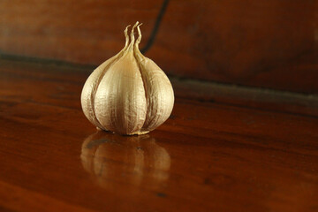 garlic clove studio shot on wooden table background. garlics still photo.
