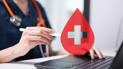 Professional health care worker doctor physician holding blood icon for blood donation concept