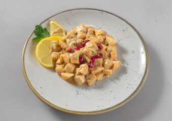 Aloo Chaat cold appetizer from traditional Indian cuisine with potatoes, pineapple, apples, mayonnaise, fresh tomato, sugar and spices seen up close and isolated on a white background