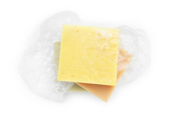 Stack of soap bars with foam on white background, top view