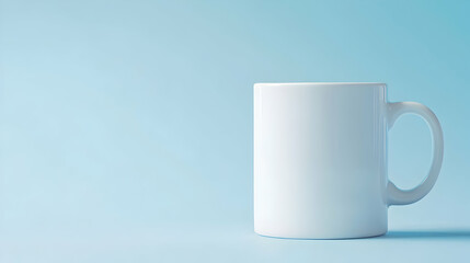 A simple white mug set against a calming blue background, perfect for showcasing beverages, tea, or coffee. Ideal for minimalist designs and beverage-related themes.