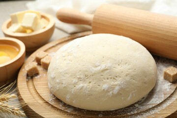 Rolling pin and different ingredients on light table, closeup