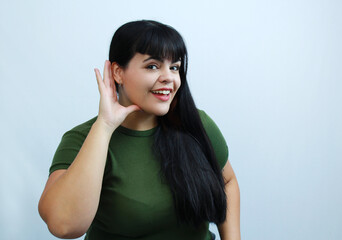 Curious woman listening attentively, hand near ear, expressing curiosity and happiness. Perfect for...