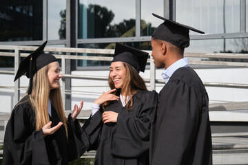 Group of Graduates Celebrating Academic Achievement Outdoors