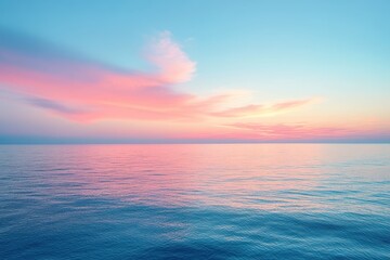 Fototapeta premium A serene aerial view showcases a tranquil ocean beneath a pastel pink and blue sky, creating a peaceful and harmonious landscape.