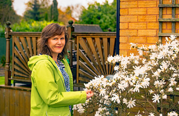 Young woman with magnolia flowers.