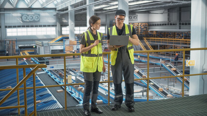 Autonomous Sortation Fullfilment Center: Two Specialist Workers Optimize Productivity of Package Order Delivery to Customers Worldwide. Conveyor Belt Logistics and Transportation Warehouse Facility