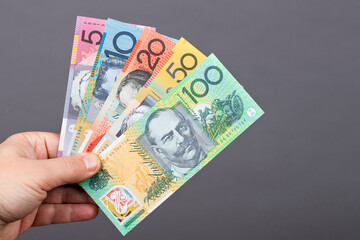 Australian money in the hand on a gray background
