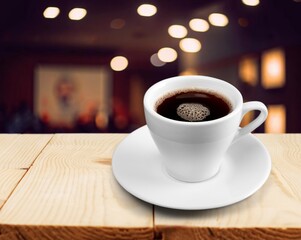 Tasty hot coffee in white cup on table