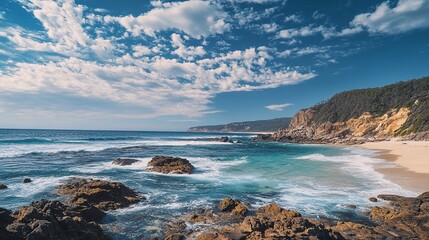 Blue ocean beach with small rocks and shiny sand