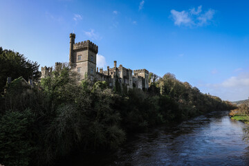 View of Lismore Castle, Ireland, showcasing its stunning Gothic architecture and scenic riverside location
