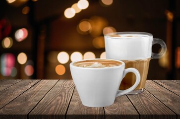 Tasty hot coffee in white cup on table