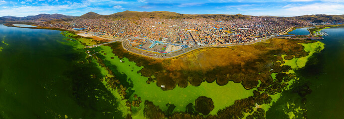 Aerial panorama of Puno with Lake Titicaca in Peru, South America.