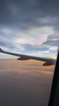 nacreous cloud from the flight, polar stratospheric cloud, known to reflect colored light after sunset and before sunrise